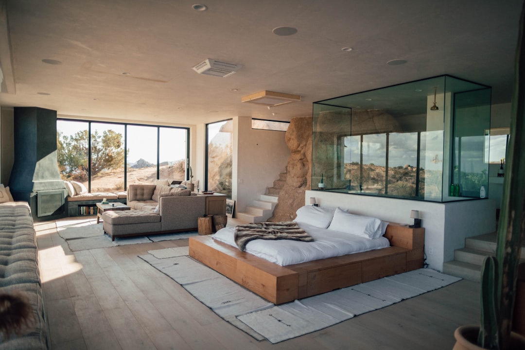 Modern living room with smart lighting and automated shades, Southern California view
